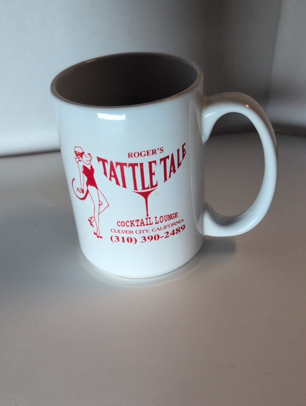 Roger's Tattle Tale White Ceramic Mug with Red Logo
